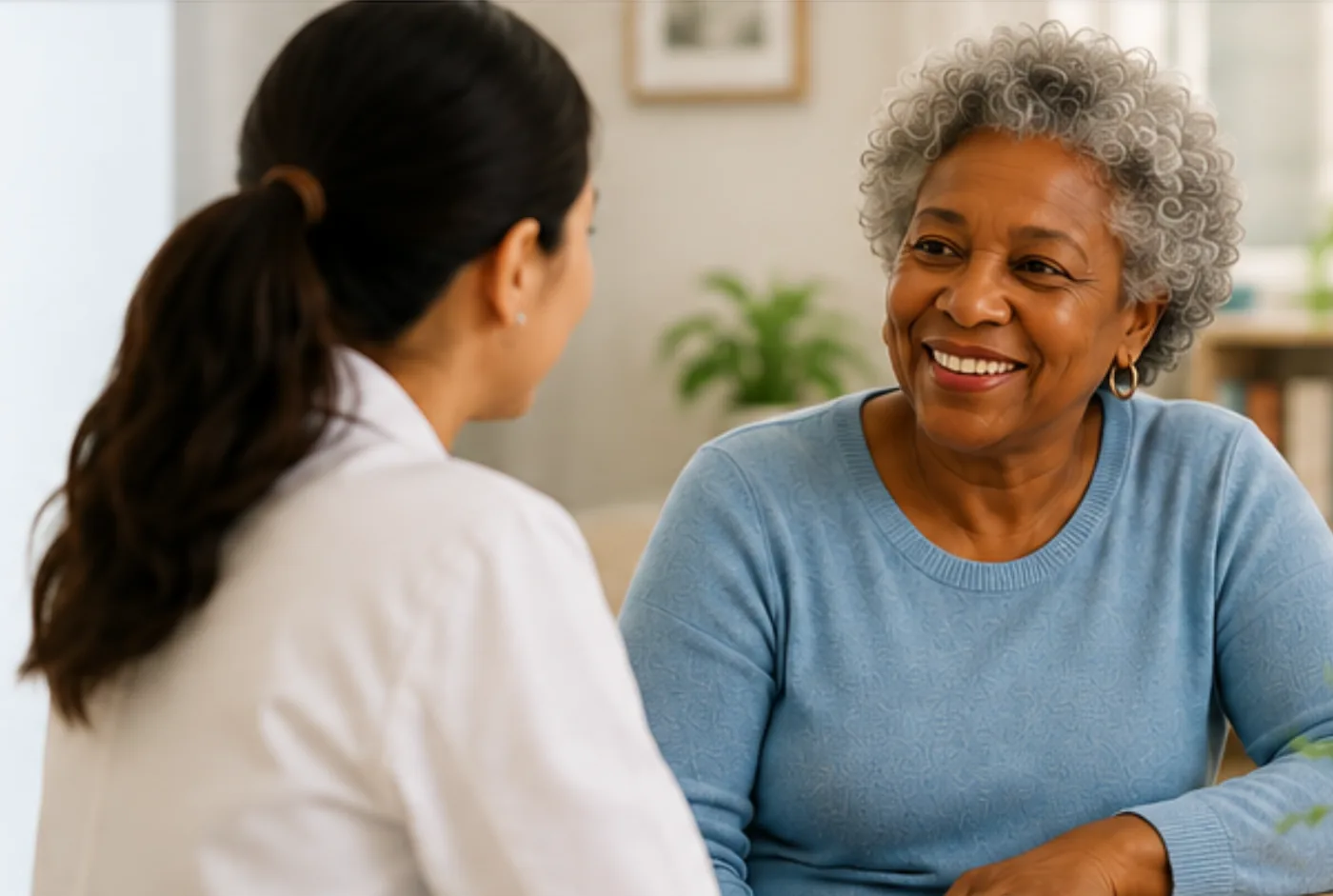 Illustration of a healthcare professional and patient engaged in conversation, representing person-centered care.